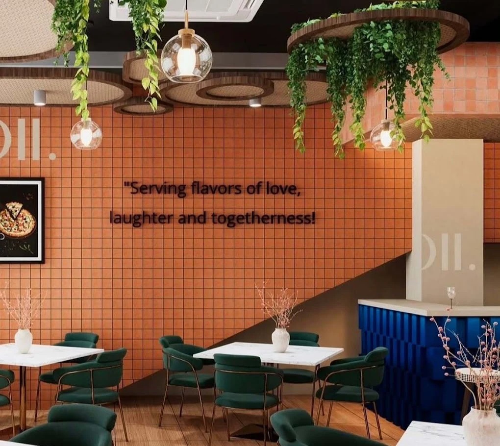 Terracotta tiled wall with emerald velvet chairs