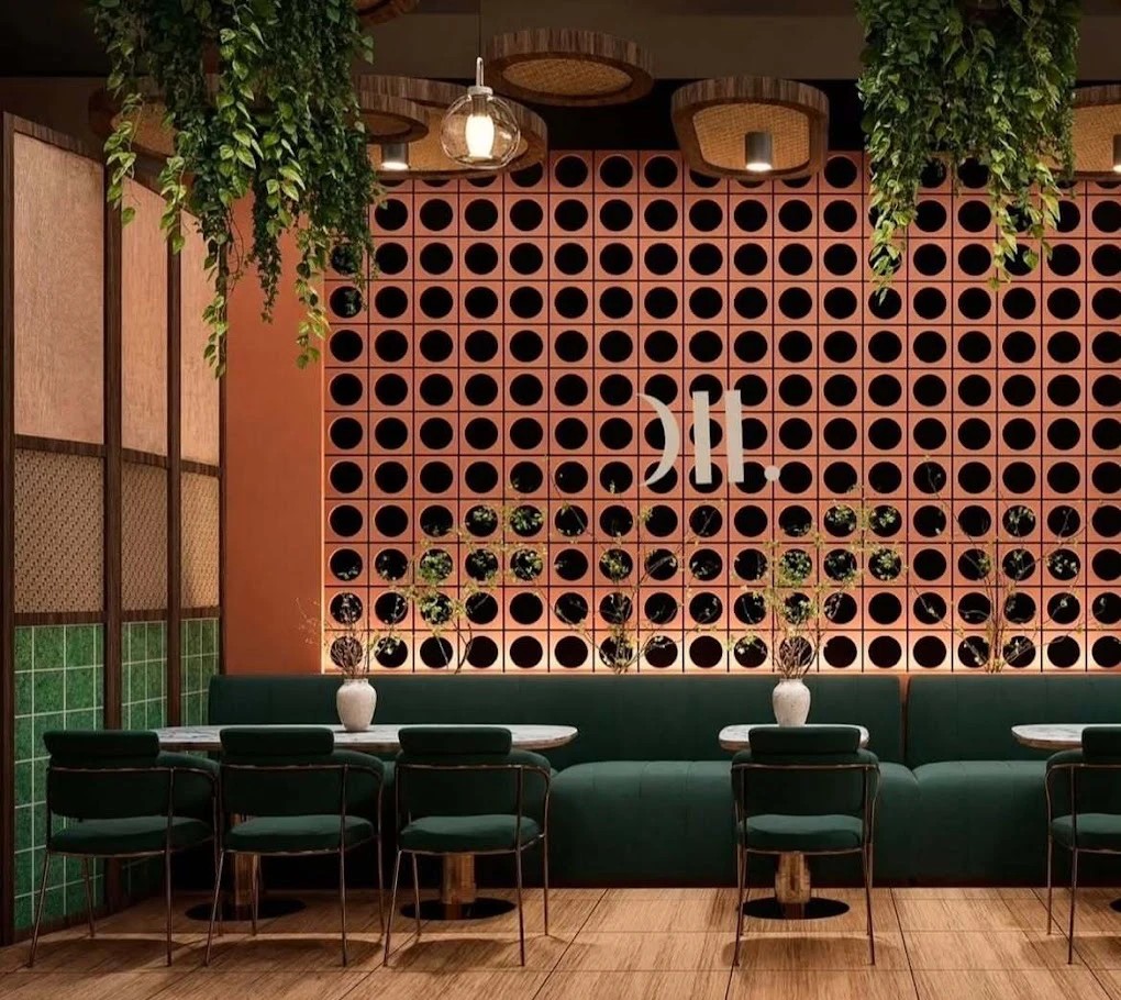 Perforated terracotta wall with banquette seating